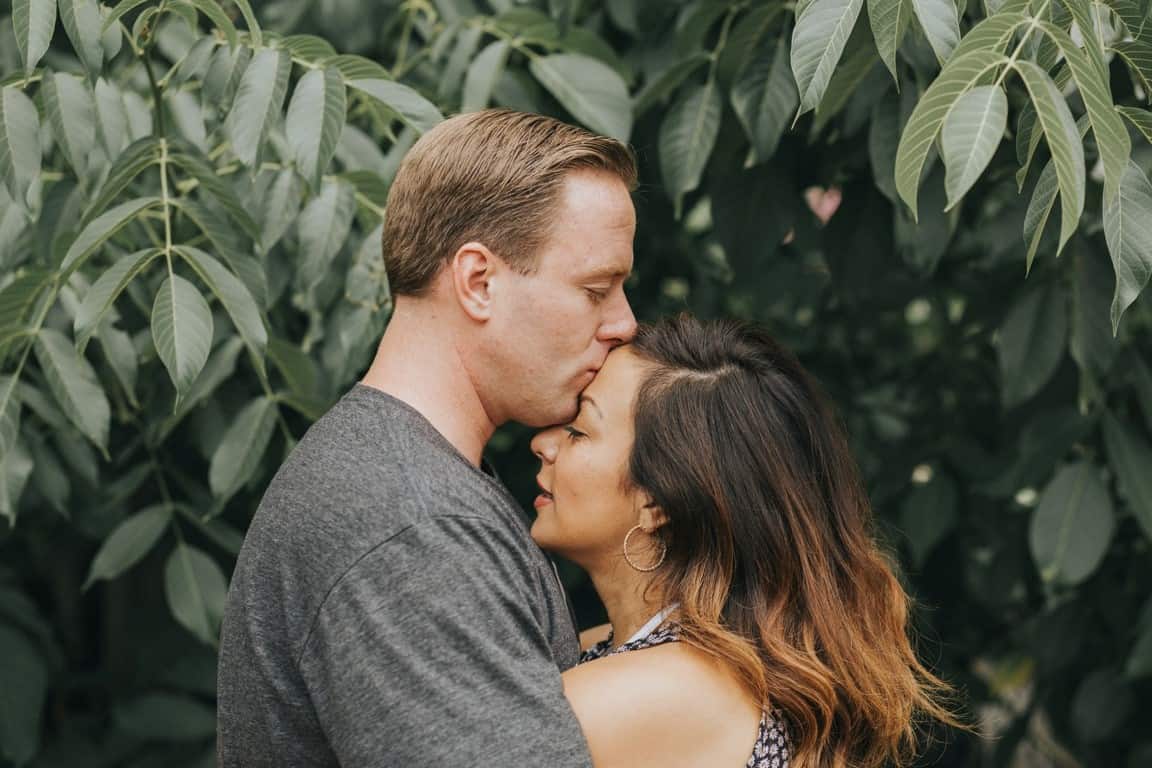 man kissing forehead