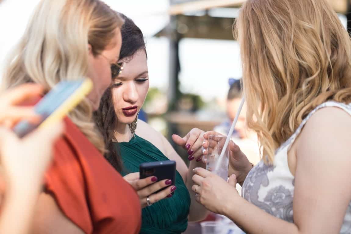 women checking phones