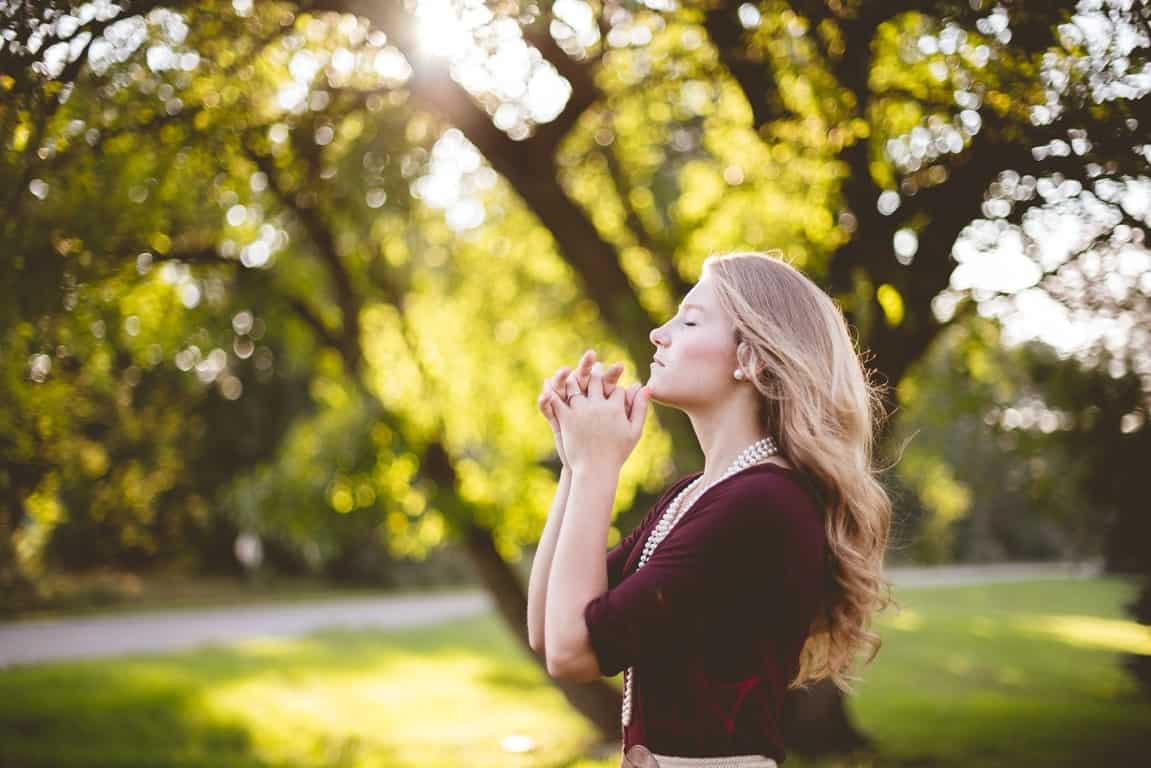 blonde woman praying