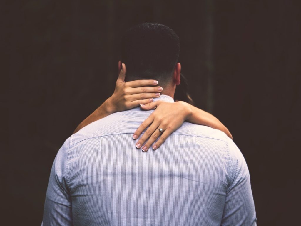 man being held by a woman