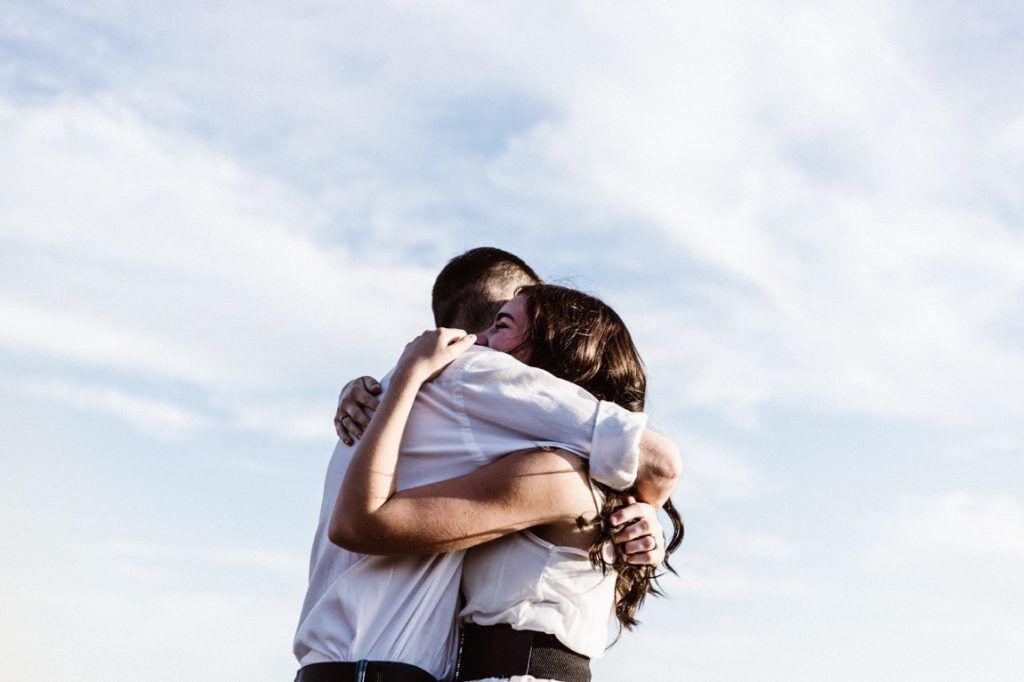 man and woman hugging each other