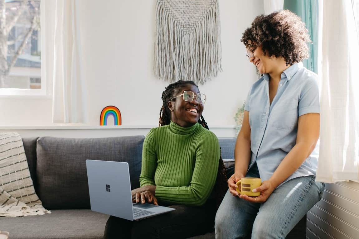 two woman smiling at each other