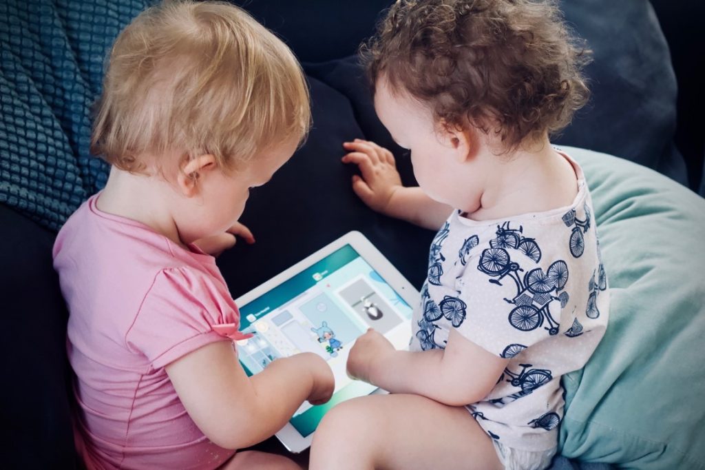 babies playing with an ipad