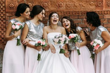 Cute bridesmaids and a bride are laughing