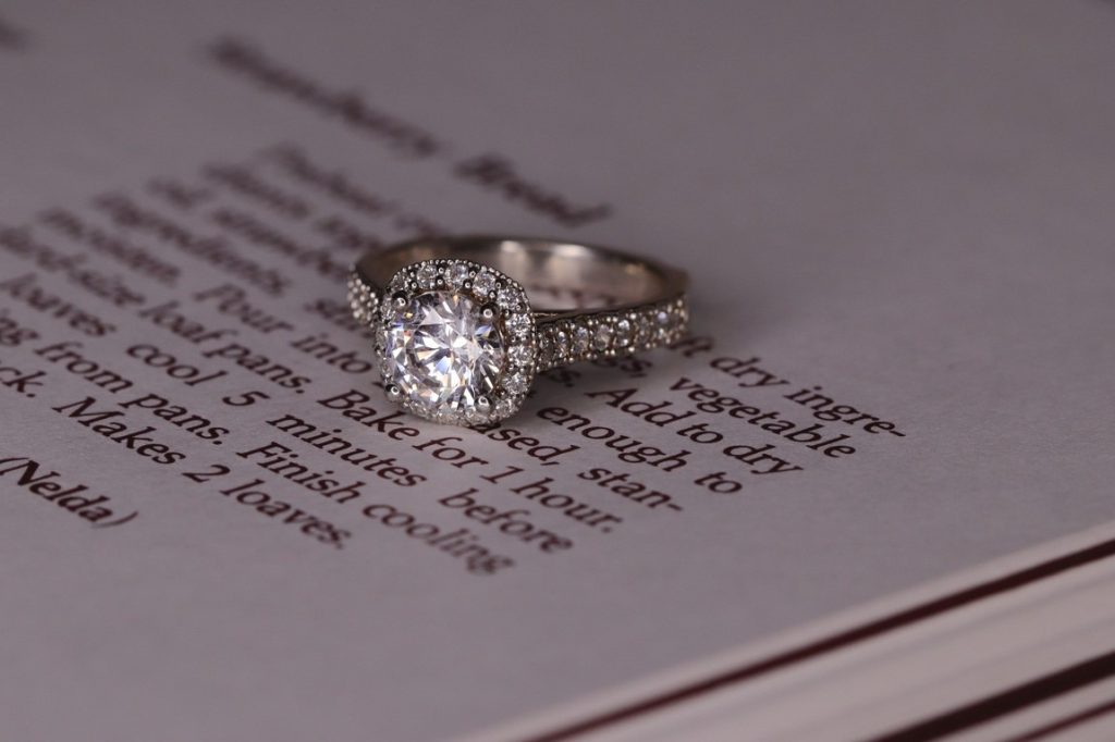 engagement ring on top of a book