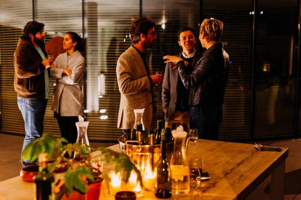 friends talking during rehearsal dinner