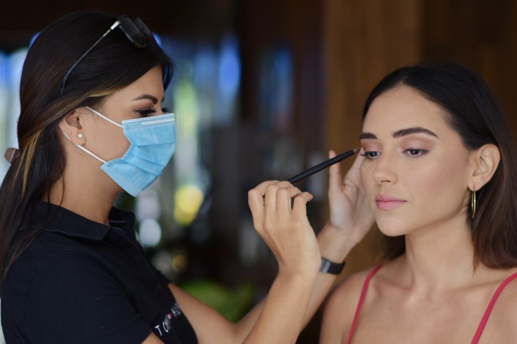 make up artist putting on a woman's make up