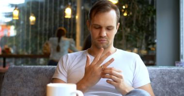 man takes off wedding ring