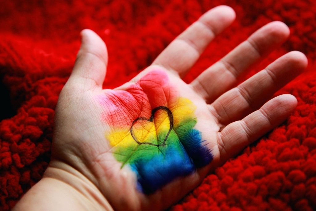 rainbow paint with heart on hand
