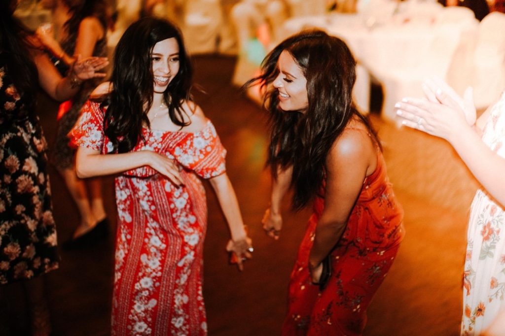 two woman dancing on a party