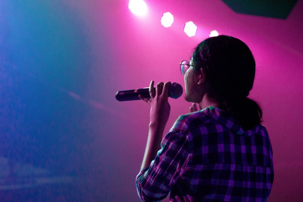 woman holding a mic