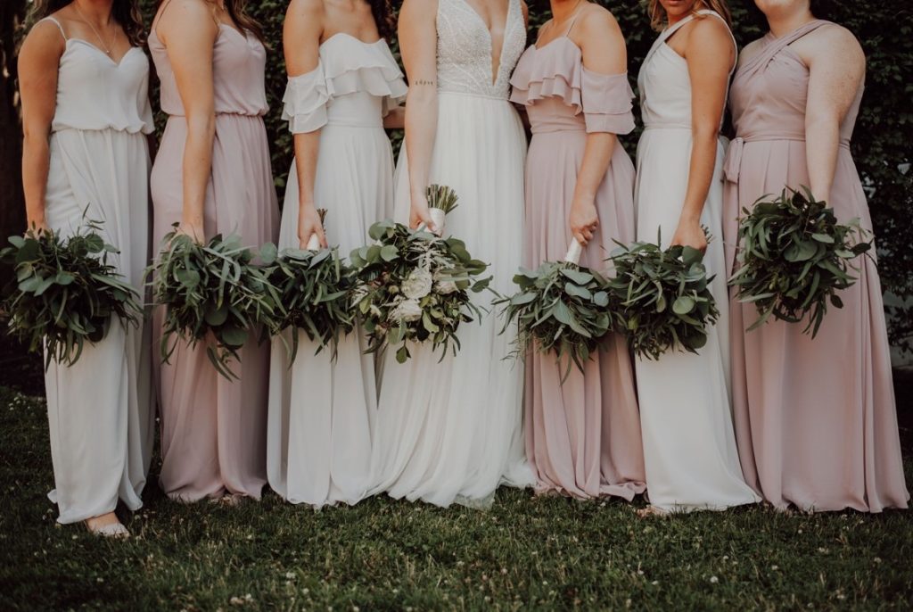 bride and bridesmaid holding bouquet