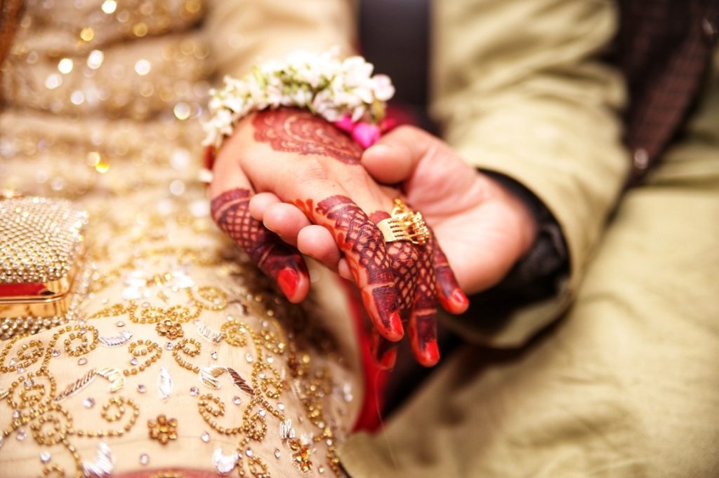 bride and groom holding hands