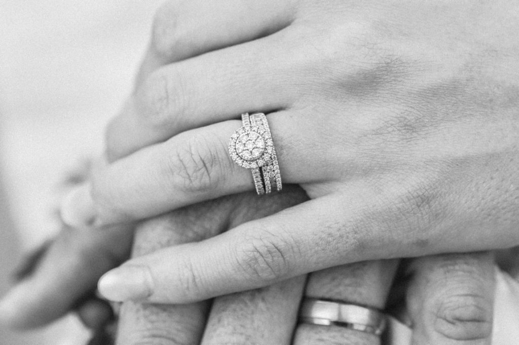 couple holding hands showing off wedding ring