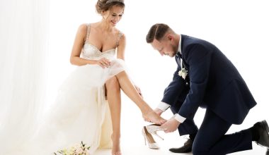 groom taking off bride's shoes