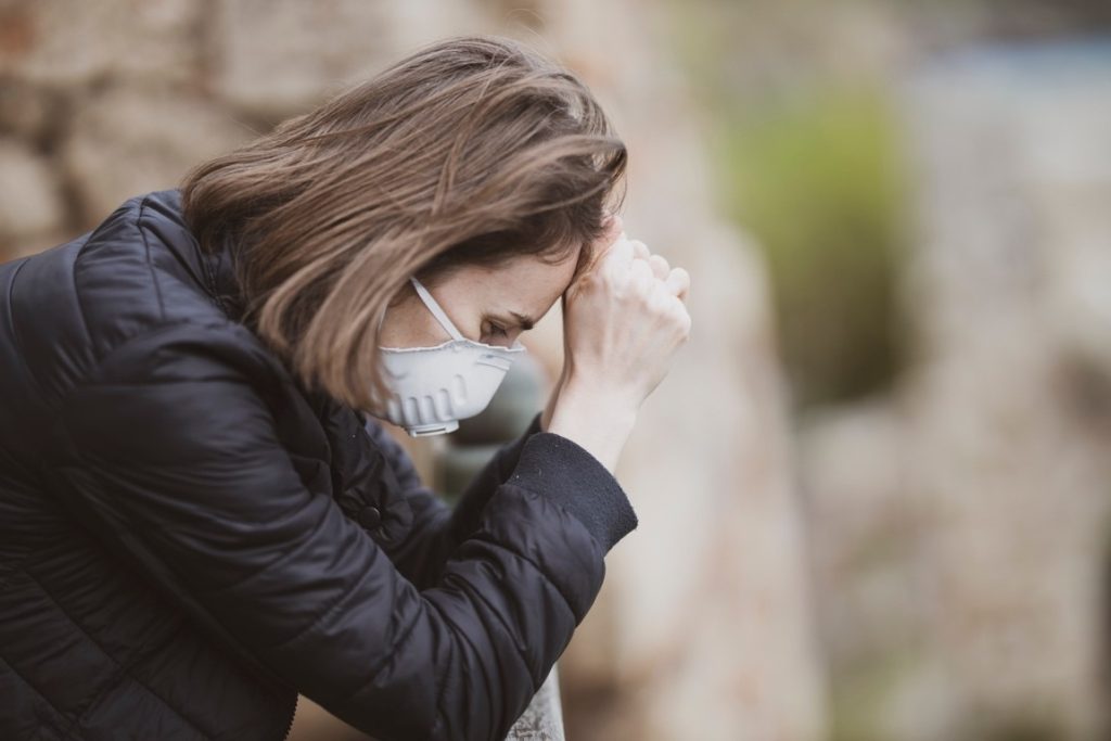 sad woman wearing a mask