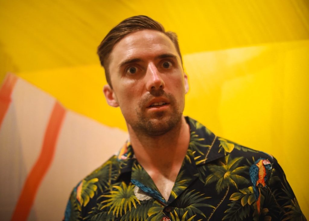 shocked man wearing Hawaiian clothes