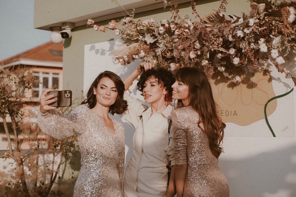 three friends taking a selfie at a wedding