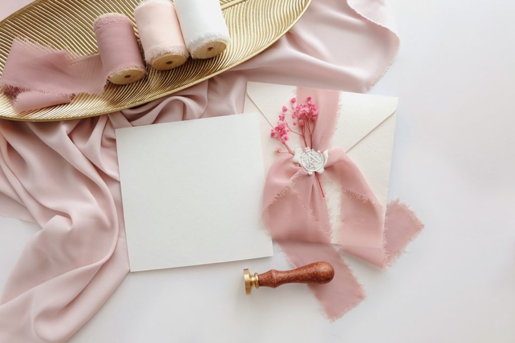 wedding invitation with pink silk and pink baby's breath flower