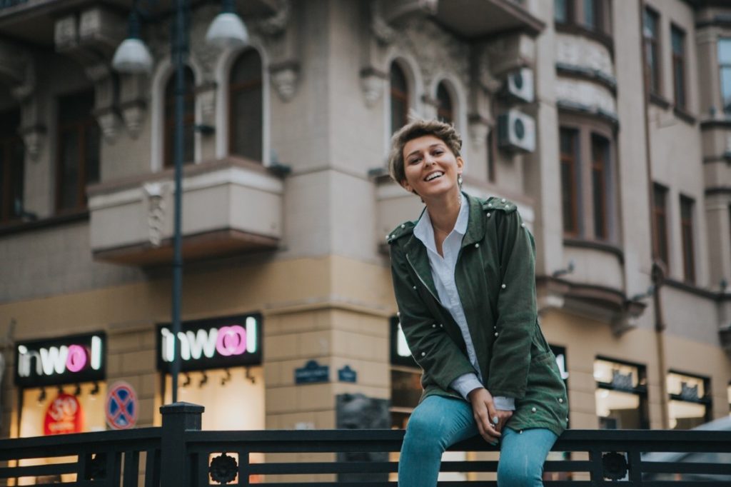 woman sitting on a railing