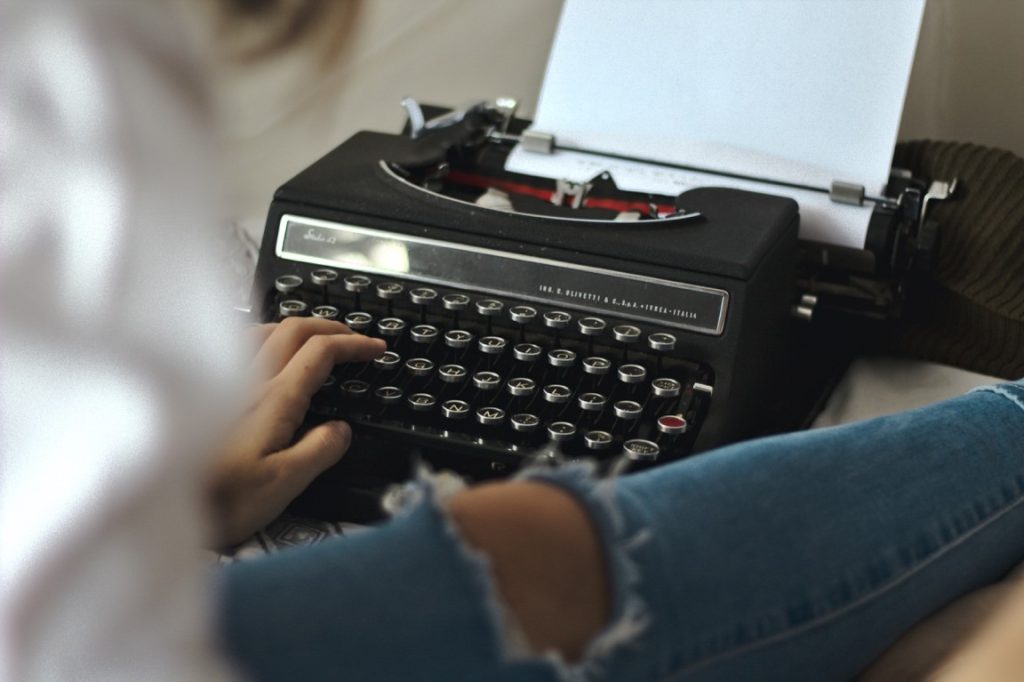 woman writing at a typewriter