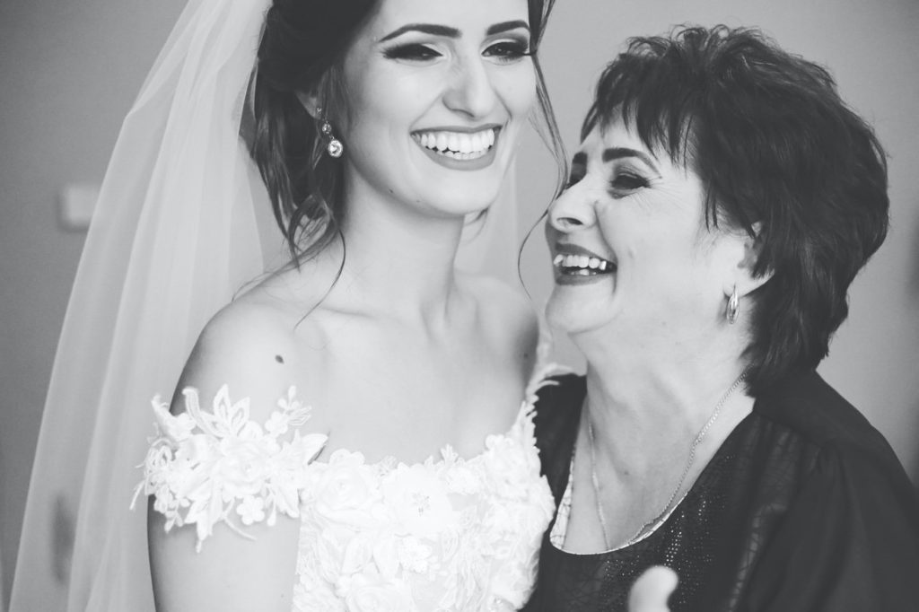 beautiful bride and her mother laughing