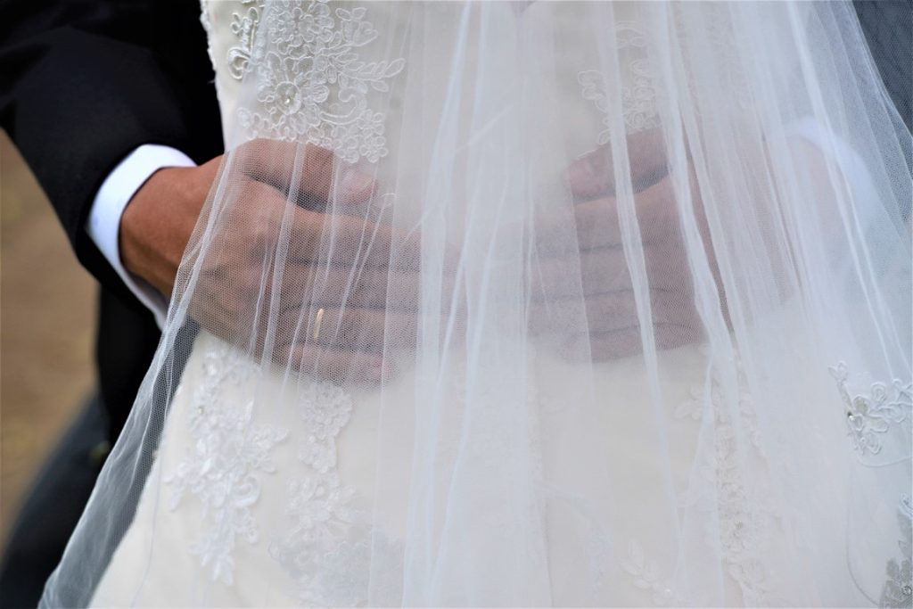 groom hugging bride