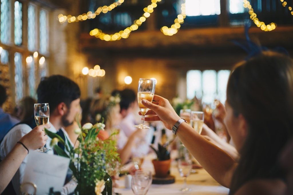 guests raising their glasses at a wedding