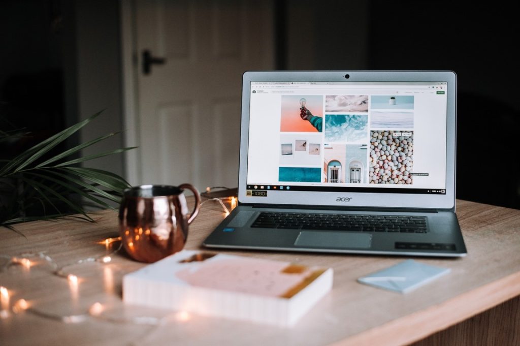 laptop and book on a table