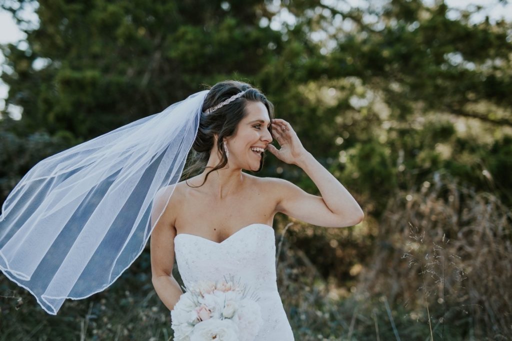 smiling bride wearing a veil