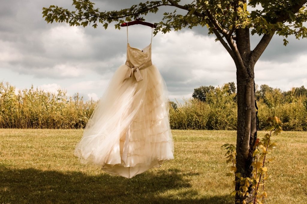wedding dress hanging on a tree