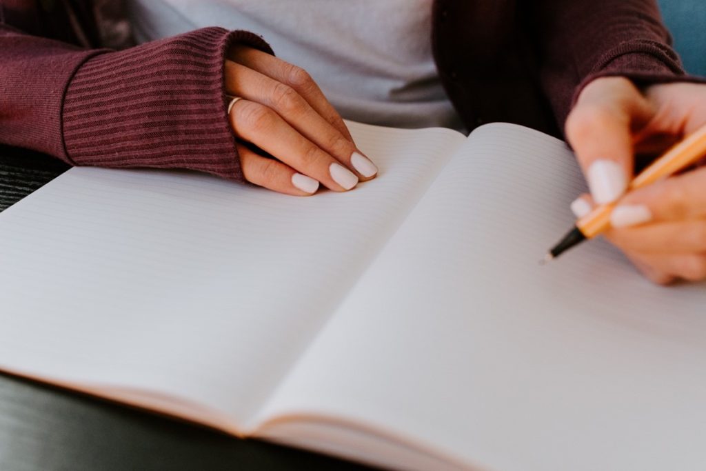 woman drinking on a blank notebook