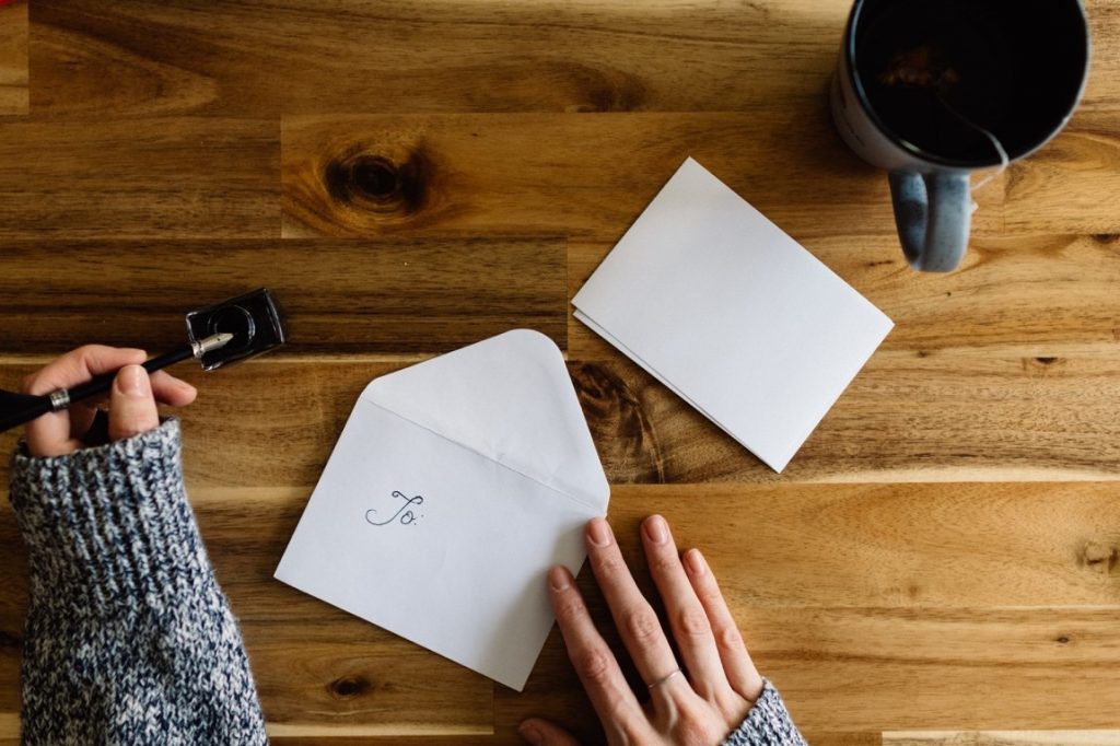 woman finishing up a letter