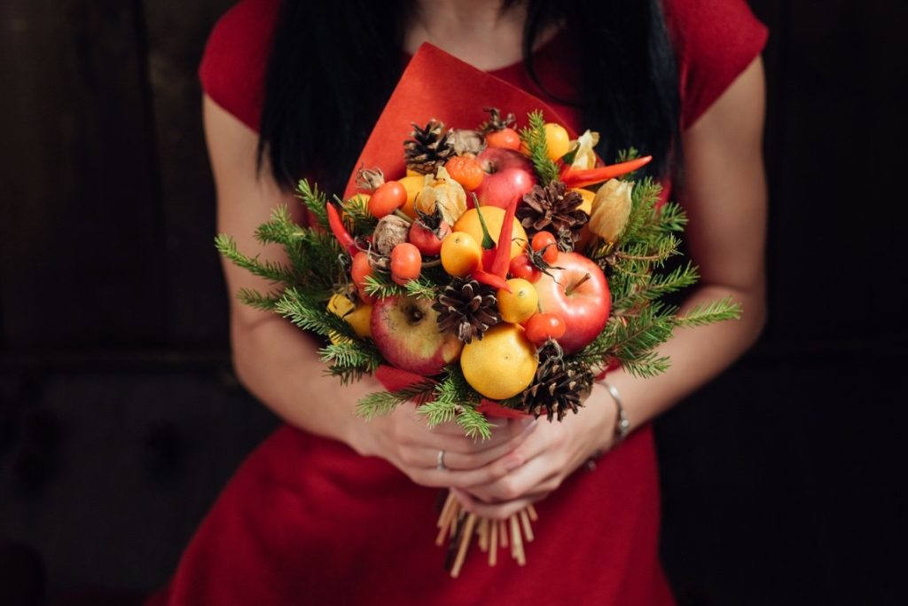 woman holding fruit bouquet