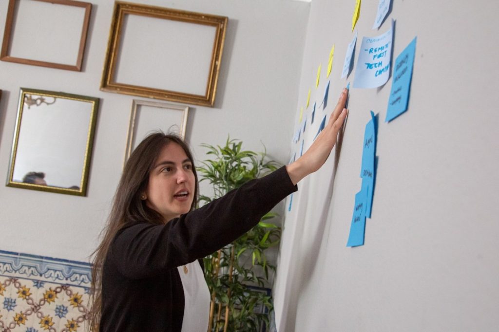 woman putting sticky notes on the wall