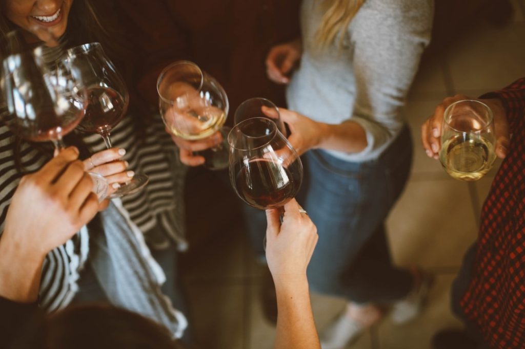 women clinking wine glasses on a bridal shower