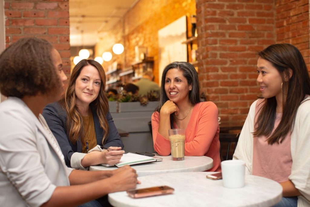 women talking in a dine