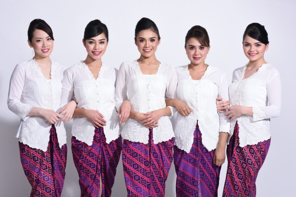 Indonesian women wearing kebaya blouse and sarong skirt