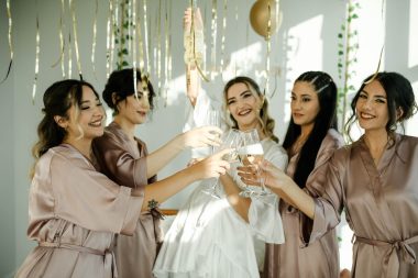 bride and friends drinking champagne