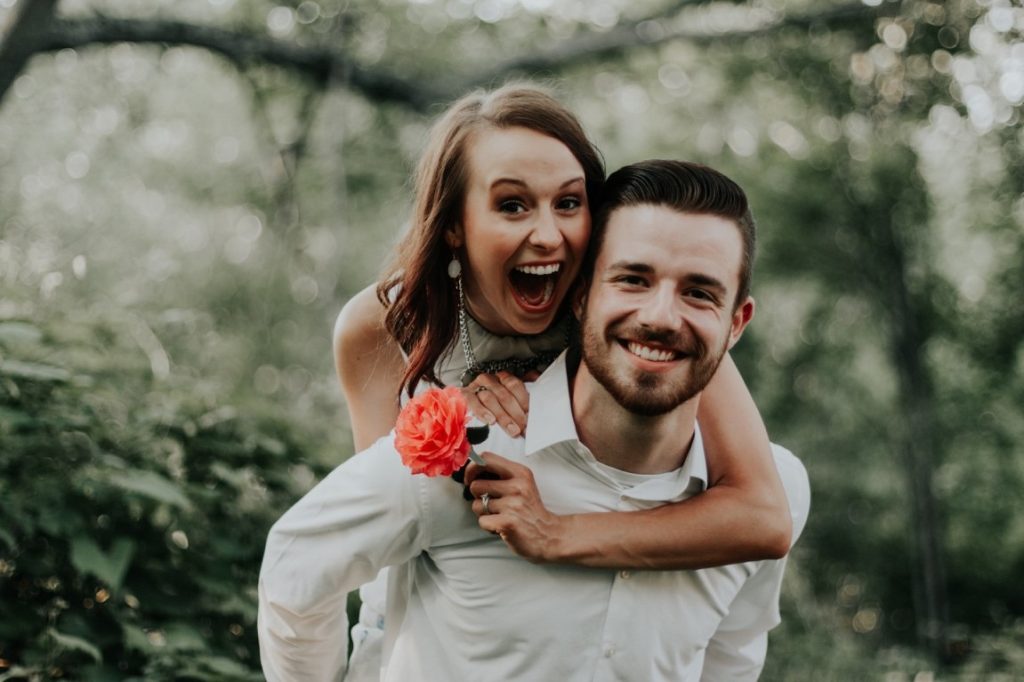 bride piggyback riding her husband