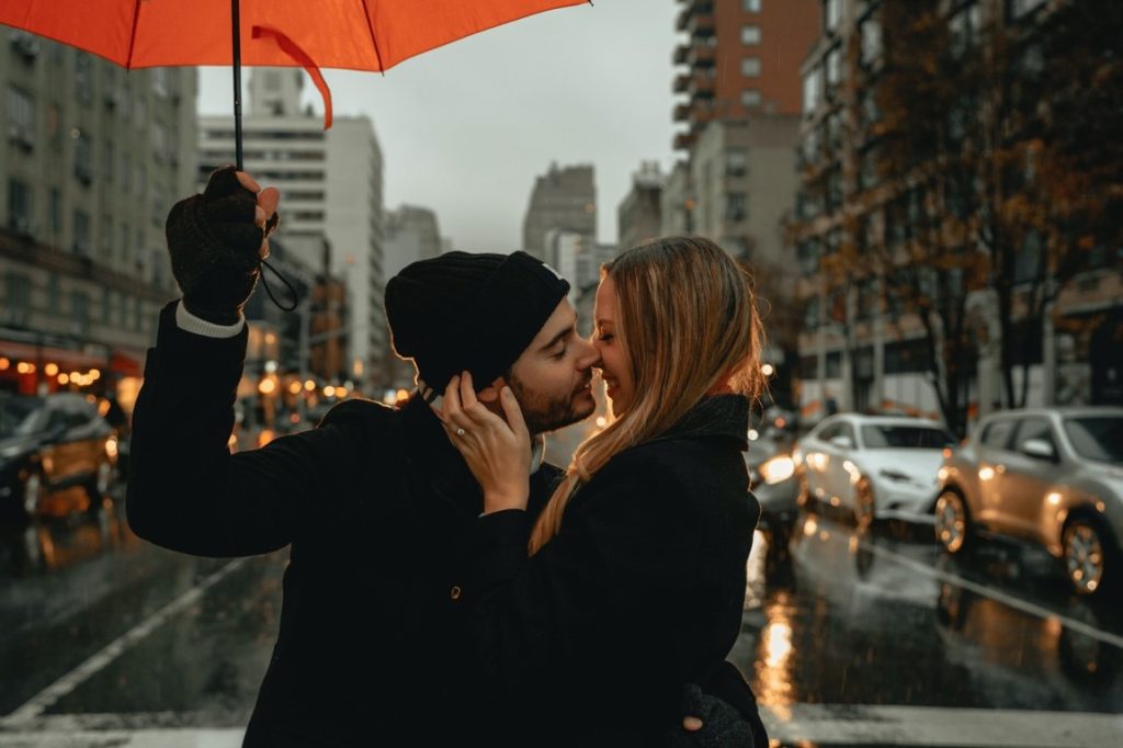 couple kissing under umbrella