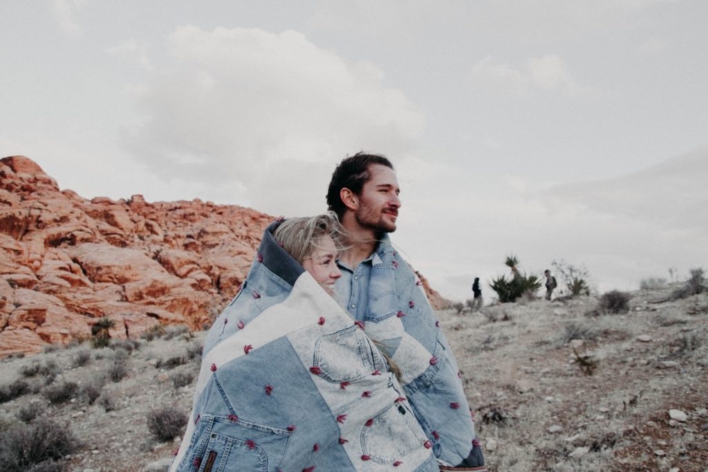 couple wearing denim blanket