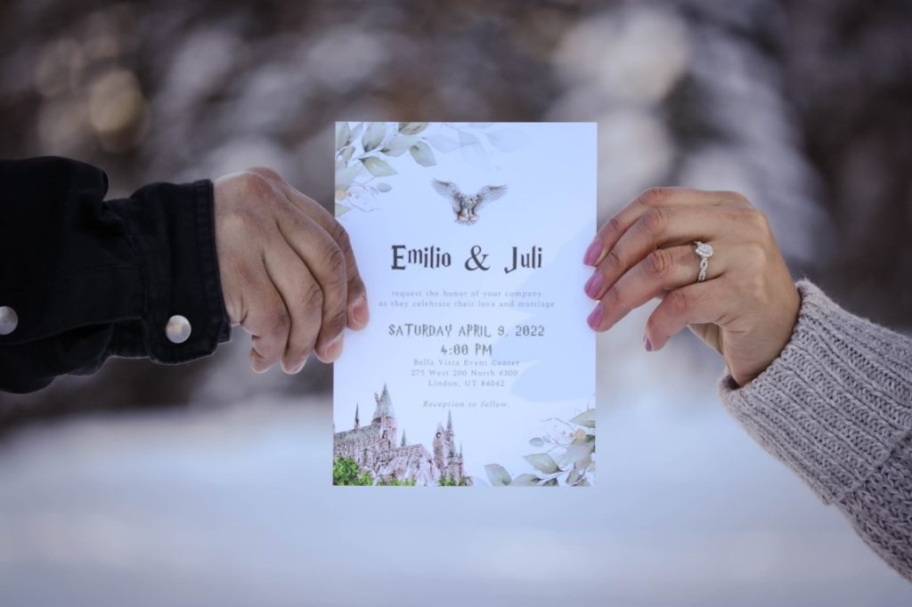 engaged couple holding wedding invitation