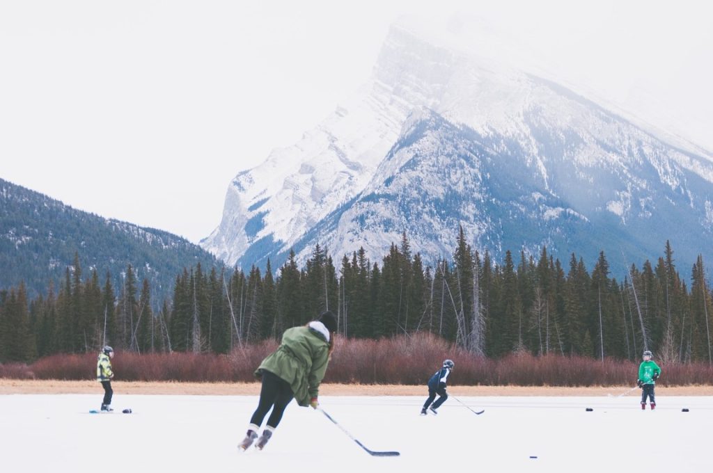 group of friends playing ice hockey