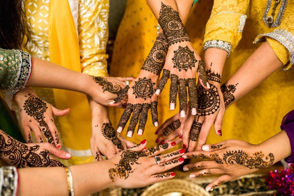 hands of women with henna