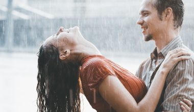 man and woman bathing in the rain