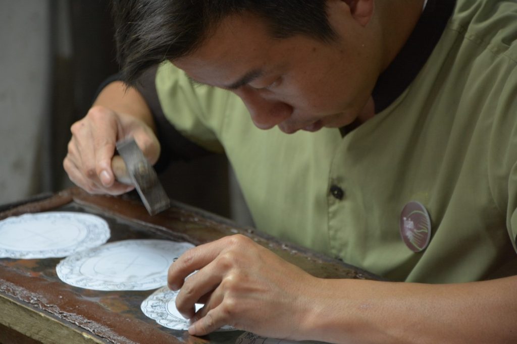 man hammering a diamond