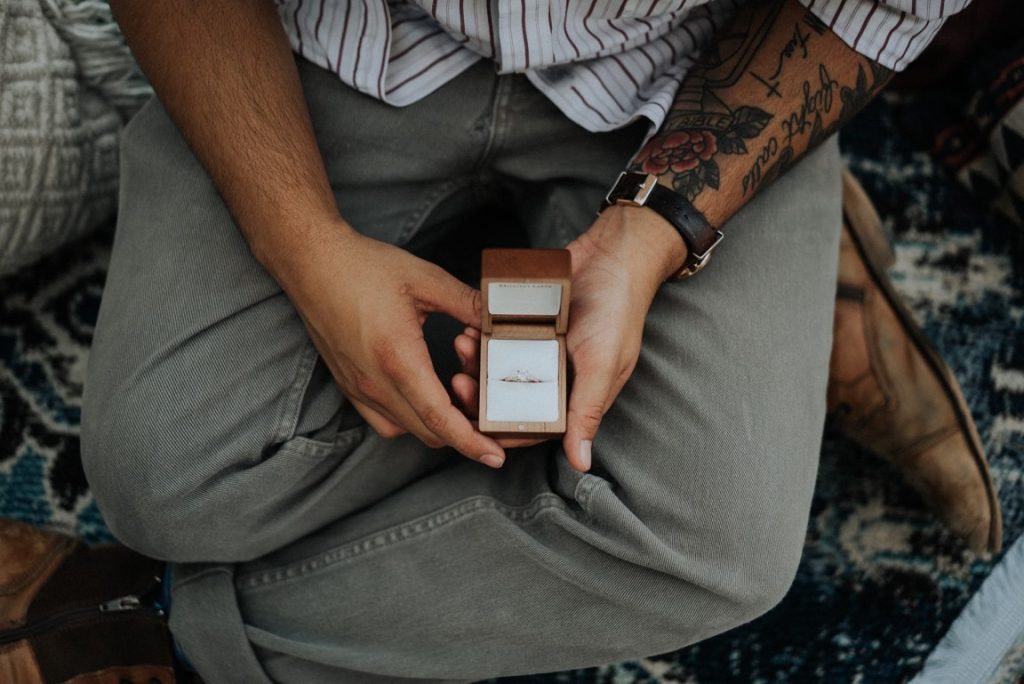 man holding an engagement ring