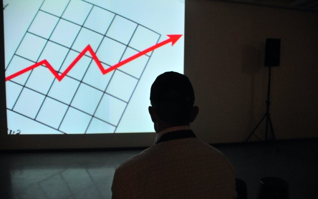 man looking at a graph in a projector