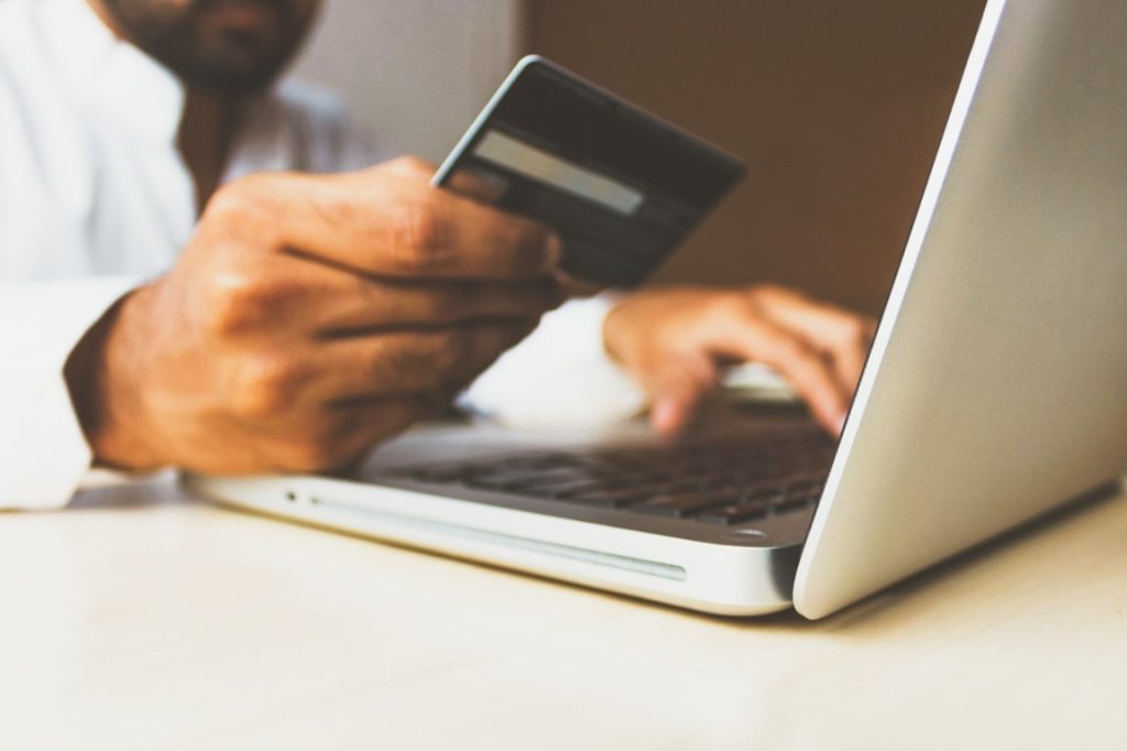 man looking at his credit card